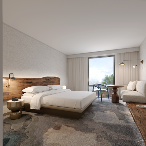 A modern hotel room with a double bed, stylish furniture, carpet, TV, and natural lighting from a window with a view.
