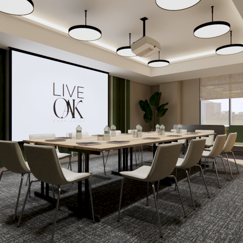A modern conference room with a large screen, table, chairs, and ceiling lights.