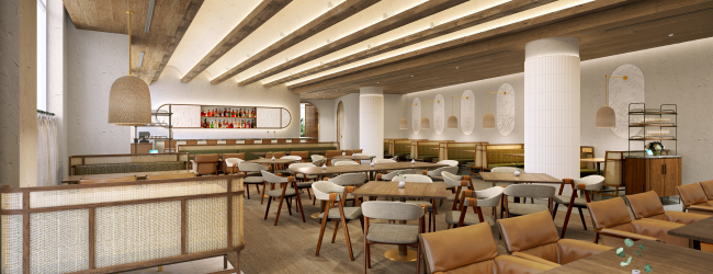A modern, spacious restaurant interior with wooden tables, beige chairs, and soft lighting, creating a warm and inviting atmosphere.
