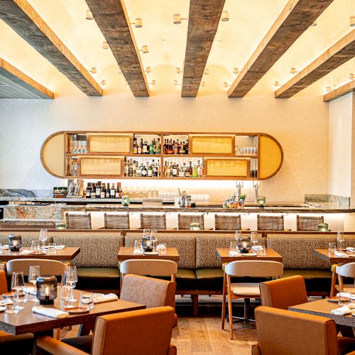 A cozy classroom full of desks and a chalkboard, warm lighting, and a banner reading &ldquo;Welcome&rdquo; at the front of the room.