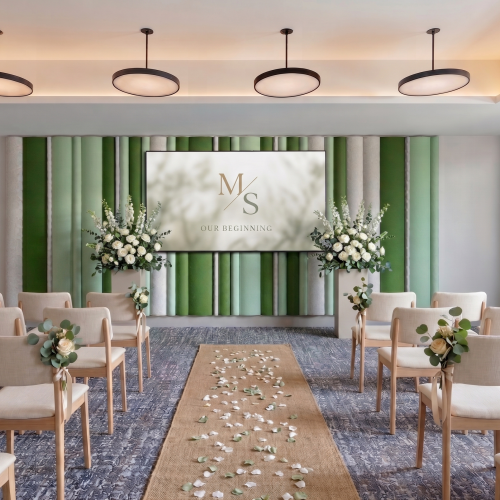 Wedding chapel setup: rows of chairs, aisle runner scattered with petals, floral arrangements, green curtains, and a &ldquo;Our Beginning&rdquo; sign.